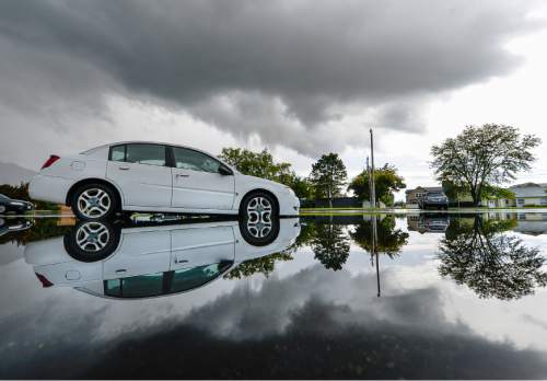 Francisco Kjolseth | The Salt Lake Tribune
A downpour fills a parking lot with water as it mirror's storm clouds that unleashed pockets of rains along the Utah valley on Friday, Oct. 2, 2015.