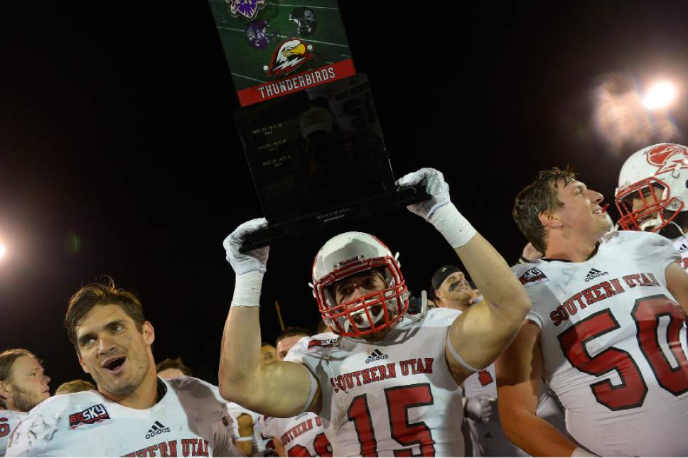 Leah Hogsten  |  The Salt Lake Tribune
SUU raises the rivalry trophy between the two teams in celebration of their win.  Southern Utah University defeated Weber State University 44-0, October 2, 2015 at Stewart Stadium in Ogden.