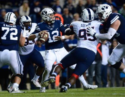 Scott Sommerdorf   |  The Salt Lake Tribune
BYU quarterback Tanner Mangum (12) rears back to pass during first half play. UCONN and BYU were tied 7-7 at the half, October 2, 2015.