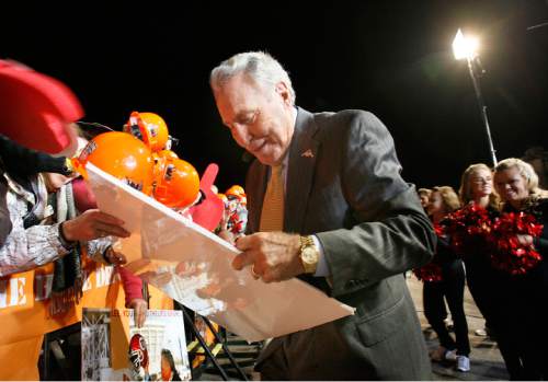 Scott Sommerdorf  l  The Salt Lake Tribune

ESPN GameDay analyst Lee Corso autographs a sign for a Ute fan before the show began. The ESPN College GameDay program did its broadcast at the University of Utah prior to the TCU at Utah game, Saturday, November 6, 2010.
