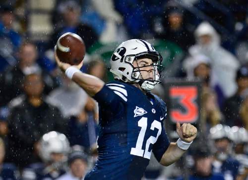 Scott Sommerdorf   |  The Salt Lake Tribune
BYU quarterback Tanner Mangum (12) throws as rain comes down during second half play. BYU beat UCONN 30-13, Friday, October 2, 2015.