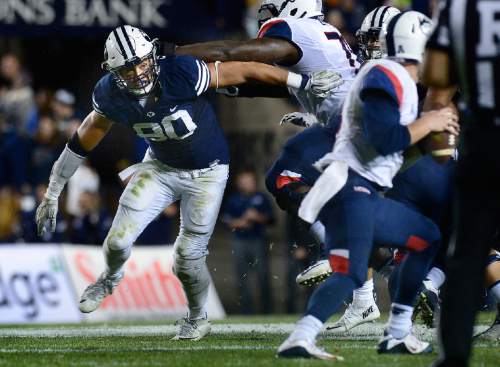 Scott Sommerdorf   |  The Salt Lake Tribune
BYU defensive lineman Bronson Kaufusi (90) spins as he rushes Connecticut quarterback Bryant Shirreffs (4) during second half play. BYU beat UCONN 30-13, Friday, October 2, 2015.