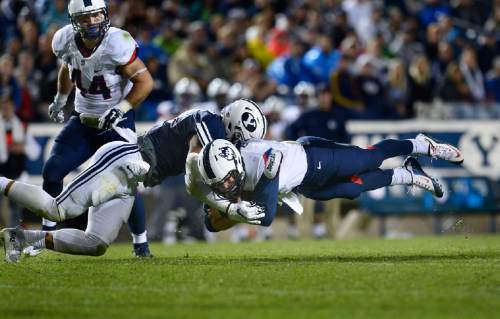 Scott Sommerdorf   |  The Salt Lake Tribune
Connecticut quarterback Bryant Shirreffs (4) launches himself at the end of a run during second half play. BYU beat UCONN 30-13, Friday, October 2, 2015.