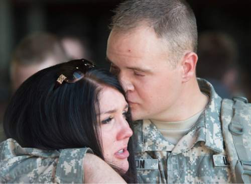 Rick Egan  |  The Salt Lake Tribune

Eric Larson, Eagle Muontain, hugs his wive Cami, before boarding the plane with other soldiers of the 116th Engineer Company (Horizontal), Utah National Guard,  as they leave for training before their deployment in Kuwait, Sunday, October 4, 2015.