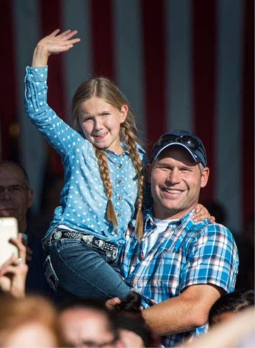 Rick Egan  |  The Salt Lake Tribune

Kyle Wilson, Spanish Fork, holds Leah Ford, 8, as she waves goodbye to her uncle, Luke Morgan, as he boarded the plane with other soldiers of the 116th Engineer Company (Horizontal), Utah National Guard, left for Kuwait  from the Roland Wright Air Base in Salt Lake City, Sunday, October 4, 2015.