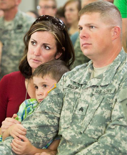 Rick Egan  |  The Salt Lake Tribune

Melissa Jessop, and her husband Ryan hold their son Zach, 5, as they listen to the program, before boarding the plane with other soldiers of the 116th Engineer Company (Horizontal), Utah National Guard, left for Kuwait  from the Roland Wright Air Base in Salt Lake City, Sunday, October 4, 2015.