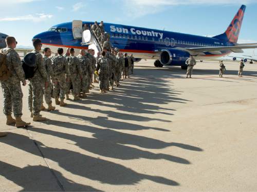 Rick Egan  |  The Salt Lake Tribune

Soldiers of the116th Engineer Company (Horizontal), Utah National Guard, board the plane at Roland Wright Air Base, as they leave for two months of training before their deployment to Kuwait, Sunday, October 4, 2015.