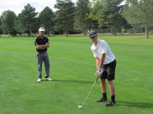 Tom Wharton  |  The Salt Lake Tribune

Lone peak golf coach Rob Stanger watches star player Carson Lundell's swing.