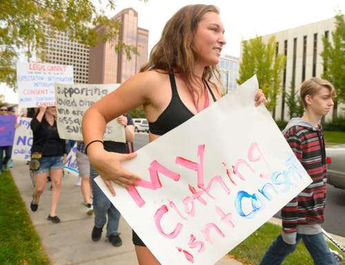 Leah Hogsten  |  The Salt Lake Tribune
Sam Kelsey holds a sign that reads, " My clothing isn't consent" while marching with about 50 people on Saturday. To kick off October's Domestic Violence Awareness Month, SlutWalk SLC held their 5th annual march and rally to the Utah Capitol.