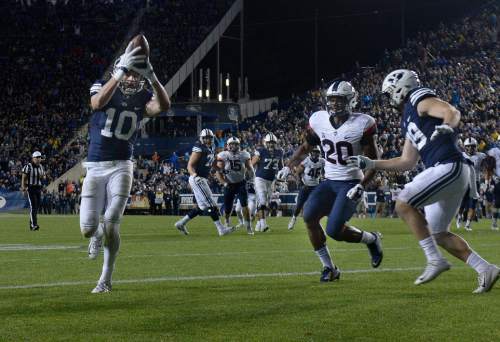 Scott Sommerdorf   |  The Salt Lake Tribune
BYU wide receiver Mitch Mathews (10) scores to give BYU a 27-13 lead during second half play. BYU beat UCONN 30-13, Friday, October 2, 2015.