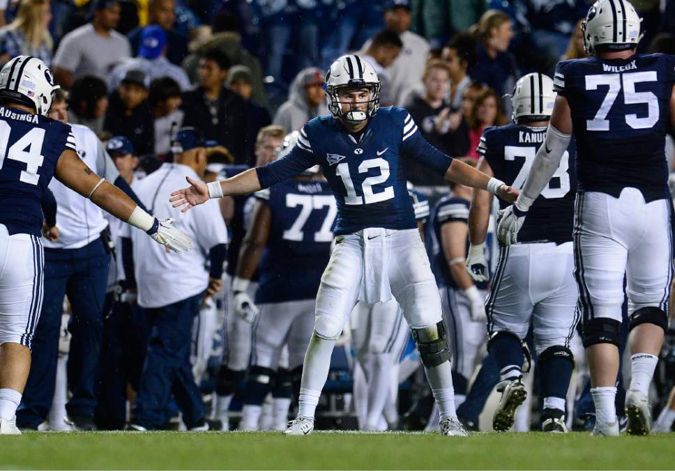 Scott Sommerdorf   |  The Salt Lake Tribune
BYU quarterback Tanner Mangum (12) congratulates the field goal team after they were successful on an attempt to give BYU their final total of 30. BYU beat UCONN 30-13, Friday, October 2, 2015.