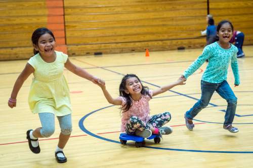 Chris Detrick  |  The Salt Lake Tribune
First graders Alyani Phanthavong, Keren Soto and Genesis Orenday Camacho play in gym class at Lincoln Elementary School Tuesday October 6, 2015.