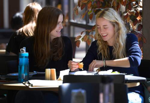 Leah Hogsten  |  The Salt Lake Tribune
l-r Bekah Christensen and Bayley Christensen (no relation) of Provo share a laugh while eating lunch at Utah Valley University's Sorenson Center, October 7, 2015. Both started school in 2015 at UVU after serving  missions in Latin America. About 3,450 more students are on campus at Utahís public colleges and universities this semester, and more than half of them are at Utah Valley University. 
A newly released snapshot of students, both full-time and part-time, shows a statewide 2 percent bump in enrollment. After staying flat for two years, the uptick is driven by a lower minimum age for missionaries announced in 2012 by The Church of Jesus Christ of Latter-day Saints. Men can now leave at 18, instead of 19; women at 19 instead of 21.