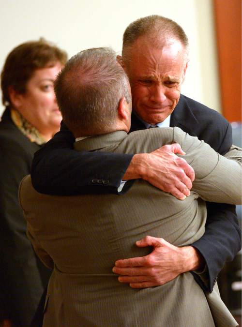 Leah Hogsten  |  The Salt Lake Tribune
Marc Sessions Jenson weeps while hugging his defense attorney Marcus Mumford after he was found not guilty Friday, January 30, 2015 of fraud and money laundering in connection with the failed Mount Holly golf and ski resort near Beaver ó a case with ties to the bribery and corruption investigation of former Utah attorneys general Mark Shurtleff and John Swallow.
Following a three-week trial, a jury of five men and three women deliberated 14 hours over two days before acquitting Jenson of four counts each of second-degree felony communications fraud and money laundering.