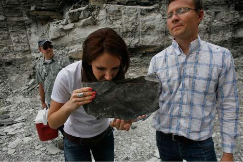 Scott Sommerdorf   |  The Salt Lake Tribune

CEO Rikki Hrenko smells a freshly broken piece of oil shale that mining engineer Ben France holds. One can easily smell the oil contained within a piece of shale that comes from the "mahogany zone" of the shale deposit. Enefit Oil's Brian Wilkinson is at left, Wednesday, August 7, 2013. 
The Estonian state-owned company Enefit American Oil seeks to develop Utah oil shale. during a tour of their proposed mine site in eastern Uintah County. They have already excavated tons of ore which has been shipped to Germany for testing.