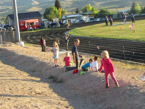Tom Wharton  |  The Salt Lake Tribune

Kids play in dirt before recent Wayne-Layton Christian football game.