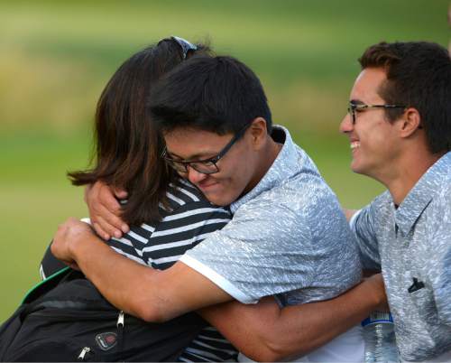 Leah Hogsten  |  The Salt Lake Tribune
Garret Furubayashi of Rowland Hall is hugged by his mother Connie Furubayashi Thursday, October 8, 2015 while walking off the 18th green after winning the 2A Boys State Championship.
