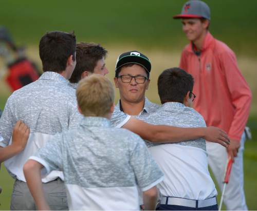 Leah Hogsten  |  The Salt Lake Tribune
Garret Furubayashi of Rowland Hall is mobbed by his teammates Thursday, October 8, 2015 while walking off the 18th green after winning the 2A Boys State Championship.