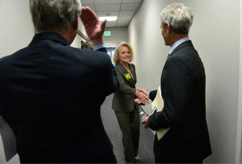 Scott Sommerdorf   |  The Salt Lake Tribune
Salt Lake City Mayoral candidates Jackie Biskupski, center, and Mayor Ralph Becker, right greet each other as they arrive at the KUED studio for the televised debate between mayor candidates, Thursday, October 8, 2015. Moderator Ken Verdoia, left is ready to flip a coin to determine the order of opening and closing statements.