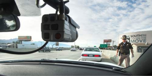 Steve Griffin  |  The Salt Lake Tribune

Utah Highway Patrol Trooper Rod Elmer issues a citation to a motorist for driving illegally in the express lane along I-15 in the Salt Lake City, Thursday, October 8, 2015, during a blitz to enforce laws about who is allowed in the freeway express lanes.
