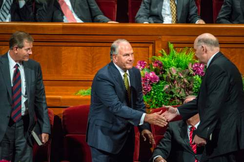Chris Detrick  |  The Salt Lake Tribune
New apostles Dale G. Renlund and Ronald A. Rasband shake hands during afternoon session of the 185th LDS General Conference at  the Conference Center in Salt Lake City Saturday October 3, 2015.  Gary E. Stevenson is at left.