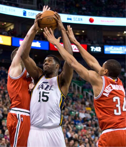 Lennie Mahler  |  The Salt Lake Tribune

Derrick Favors drives to the basket in between Miles Plumlee and Giannis Antetokounmpo in the first half of an NBA basketball game between the Utah Jazz and the Milwaukee Bucks at EnergySolutions Arena in Salt Lake City, Saturday, Feb. 28, 2015.