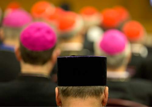 Prelates pray before the opening of a morning session of the Synod of bishops, at the Vatican, Tuesday, Oct. 6, 2015. The bishops are debating how the church can better care for Catholic families at a time when marriage rates are falling, divorce is common and civil unions are on the rise. (AP Photo/Alessandra Tarantino)