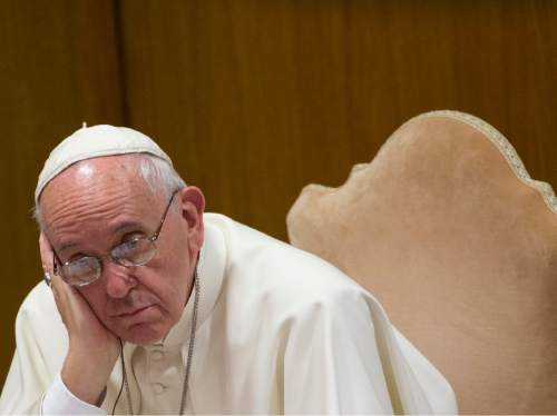 Pope Francis listens to the opening speech during a morning session of the Synod of bishops, at the Vatican, Tuesday, Oct. 6, 2015. (AP Photo/Alessandra Tarantino)