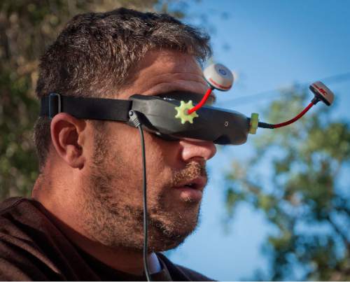 Michael Mangum  |  Special to the Tribune

David Hively, of Boise, Idaho, looks through his video goggles while controlling his drone through an obstacle course during the first Utah Cup drone race at Warm Springs Park in Salt Lake City on Saturday, October 10, 2015.
