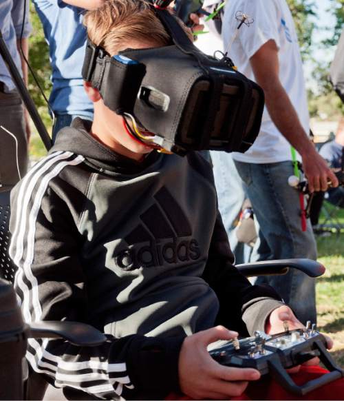Michael Mangum  |  Special to the Tribune

12-year-old Kyler Robinson, of Spanish Fork, flys his drone while watching through his video goggles during the first Utah Cup drone race at Warm Springs Park in Salt Lake City on Saturday, October 10, 2015.