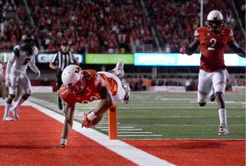 Utah running back Devontae Booker scores a touchdown against California during the first half of an NCAA college football game Saturday, Oct. 10, 2015, in Salt Lake City. (Scott Sommerdorf/The Salt Lake Tribune via AP) DESERET NEWS OUT; LOCAL TELEVISION OUT; MAGS OUT; MANDATORY CREDIT
