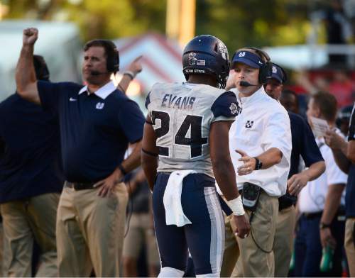 Scott Sommerdorf   |  The Salt Lake Tribune
Utah State Aggies head coach Matt Wells meets Utah State Aggies safety Marwin Evans (24) on the sidelines after Evans was ejected for spearing Utah Utes wide receiver Britain Covey (18) in the end zone. Evans was ejected on the play. Utah and Utah State were tied 14-14 at the half at Rice-Eccles, Friday, September 11, 2015.