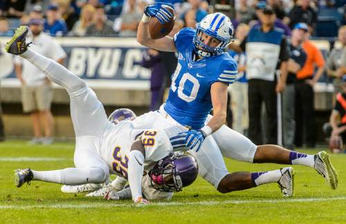 Trent Nelson  |  The Salt Lake Tribune
Brigham Young Cougars wide receiver Mitch Mathews (10) stretches the ball into the end zone for a touchdown as BYU hosts East Carolina, college football at LaVell Edwards Stadium in Provo, Saturday October 10, 2015.
