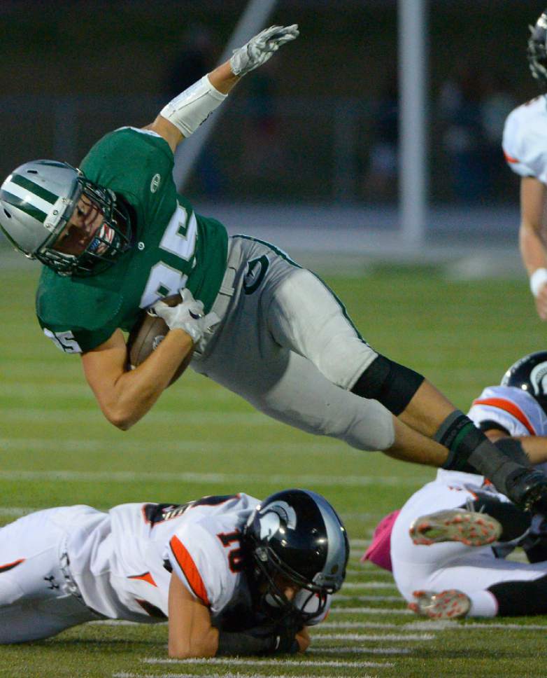Leah Hogsten  |  The Salt Lake Tribune
Olympus' Jack Anderson is brought down by Murray's Gage Cuthbertson. Olympus High School leads Murray High School, 30-7 during their football game Friday, October 9, 2015 at Olympus High School.