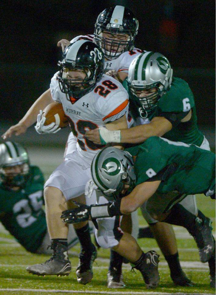 Leah Hogsten  |  The Salt Lake Tribune
Murray's Hunter Jones is taken down by Olympus' Luke Dalling and Anthony Ronquillo.  Olympus High School leads Murray High School, 30-7 during their football game Friday, October 9, 2015 at Olympus High School.