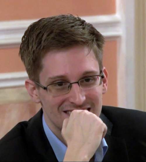 FILE - This file photo image made from video released by WikiLeaks on Friday, Oct. 11, 2013, shows former National Security Agency systems analyst Edward Snowden smiles during a presentation ceremony for the Sam Adams Award in Moscow, Russia. Snowden's Russian lawyer, Anatoly Kucherena, said Tuesday March 3, 2015 he was eager to return to the U.S. if given security guarantees, and German and U.S. lawyers were working on the issue. (AP Photo)