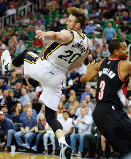 Steve Griffin  |  The Salt Lake Tribune

Utah Jazz guard Gordon Hayward (20) falls to the ground after being pulled down from behind by Portland Trail Blazers guard C.J. McCollum (3) late in the second half of the Utah Jazz versus the Portland Trailblazers preseason NBA basketball game at EnergySolutions Arena in Salt Lake City, Monday, October 12, 2015. McCollum was called for a flagrant foul and ejected from the game.