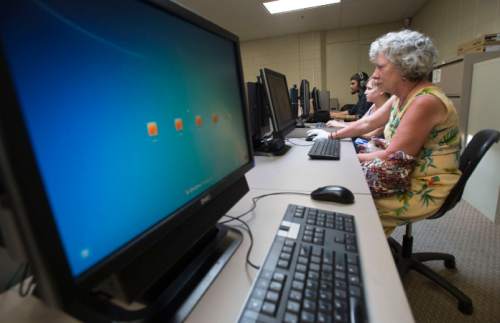Steve Griffin  |   Tribune file photo
Brandi Jensen, center, and her mother-in-law Chris Jensen use the computers in the CAT Lab at the Central City Rec Center after they finished a yoga class at the Salt Lake City center Monday, June 8, 2015. The county is proposing to do away with its CAT (Community Access to Technology) Labs.