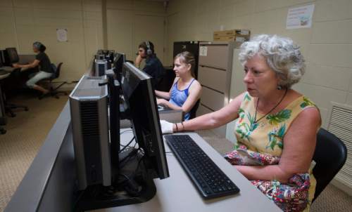 Steve Griffin  |  Tribune file photo
Brandi Jensen, center, and her mother-in-law Chris Jensen use the computers in the CAT Lab at the Central City Rec Center after the finished a yoga class at the Salt Lake City center Monday, June 8, 2015. The county is proposing to do away with its CAT (Community Access to Technology) Labs.