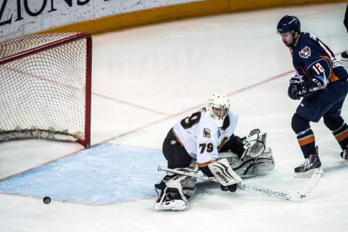 Chris Detrick  |  The Salt Lake Tribune
Utah Grizzlies' Eric Levine (79) blocks a shot from Ontario Reign's Rocco Carzo (12) during game 5 of the ECHL playoff series at the Maverik Center Saturday May 9, 2015.