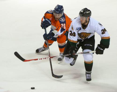 Leah Hogsten  |  The Salt Lake Tribune
Utah Grizzlies defender Connor Hardowa (24) battles Ontario Reign Matt White (20). 
The Utah Grizzlies fall to the Ontario Reign 4-2 in game four of the second round of the ECHL playoff series at the Maverik Center, Friday, May 8, 2015.