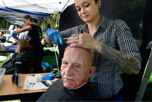 Scott Sommerdorf   |  The Salt Lake Tribune
Richard Greenlaw has his hair cut by stylist Chelsea Rose of "Haircuts for Hope" at the "Day of Dignity" in Pioneer Park, Sunday, October 11, 2015.