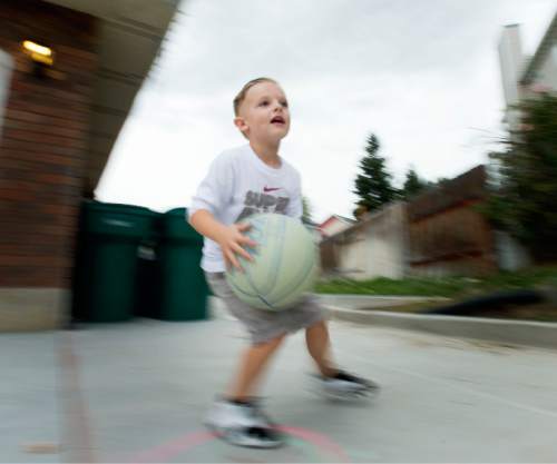 Steve Griffin  |  The Salt Lake Tribune

J.P. Gibson plays basketball on his home court in Layton, Utah Wednesday, September 30, 2015.   Gibson captured the hearts of many when the 5-year-old got the chance to participate in a Utah Jazz scrimmage last season. A year later, he is cancer free.