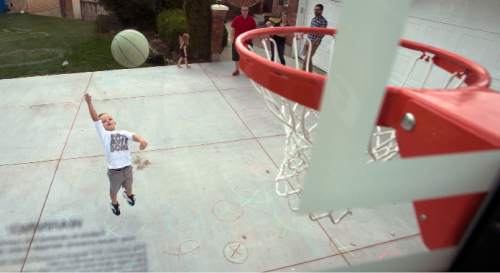 Steve Griffin  |  The Salt Lake Tribune

J.P. Gibson fires a jumper on his home court in Layton, Utah Wednesday, September 30, 2015.   Gibson captured the hearts of many when the 5-year-old got the chance to participate in a Utah Jazz scrimmage last season. A year later, he is cancer free.