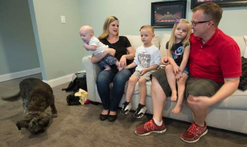 Steve Griffin  |  The Salt Lake Tribune

Josh and Megan Gibson with their children J.P., Elsie, Theo, baby, and pet dog Missy in their Layton, Utah home Wednesday, September 30, 2015. J.P. captured the hearts of many when the 5-year-old got the chance to participate in a Utah Jazz scrimmage last season. A year later, he is cancer free.