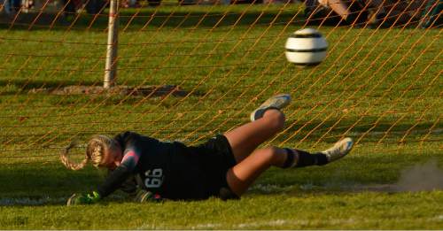 Leah Hogsten  |  The Salt Lake Tribune
A penalty kick from Davis' Mikayla Colohan hits off the goal post guarded by American Fork's goalie Savanna Empey. Davis High School girls soccer team defeated American Fork, Thursday, October 15, 2015.