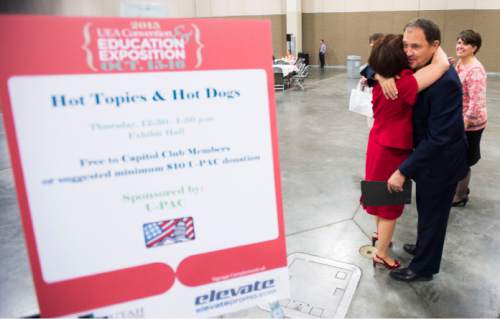 Steve Griffin  |  The Salt Lake Tribune

 UEA President Sharon Gallagher-Fishbaugh hugs Gov. Gary Herbert as he attends the Hot Topics and Hot Dogs discussion as the keynote speaker at the Annual Utah Education Association Convention & Education Exposition at the South Towne Expo Center in Sandy, Thursday, October 15, 2015.