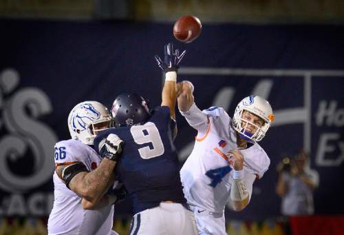 Scott Sommerdorf   |  The Salt Lake Tribune
Utah State Aggies LB Kyler Fackrell (9) gets his hand up in the face of Boise State Broncos QB Brett Rypien (4) as he passes during second half play. Rypien passed 50 times during the game. Utah State defeated Boise State 52-26 in Logan, Friday, October 15, 2015.