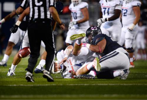 Scott Sommerdorf   |  The Salt Lake Tribune
Boise State Broncos QB Brett Rypien (4) fumbles as he is sacked by Utah State Aggies DE Ricky Ali'ifua (95) during first quarter play. Utah State recovered and later scored a TD to go up 17-3. Utah State led Boise State 17-3 after one quarter of play, Friday, October 15, 2015.