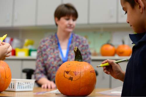 Scott Sommerdorf   |  The Salt Lake Tribune
Plymouth Elementary teacher Tara Fredley works with students who were decorating pumpkins in her 2nd grade class, Thursday, October 1, 2015. Fredley is one of the most experienced teachers at the school.